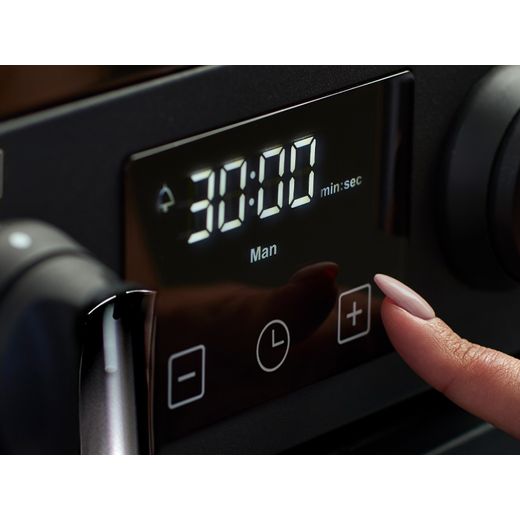 Stoves Richmond Deluxe 100Ei RTY 100cm Electric Range Cooker with Induction Hob - Black - person using control panel shot 