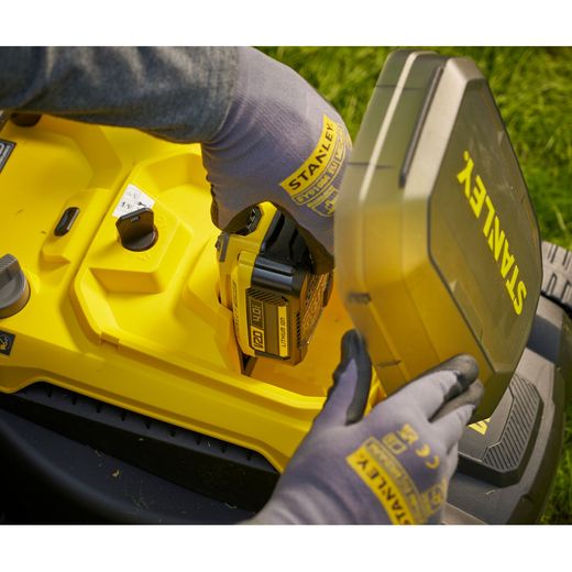 Stanley Fatmax V20 Cordless Lawn Mower - lifestyle - person inserting battery