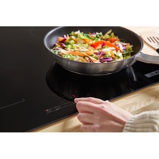 Bosch Series 4 PWP611BB5B 59cm Induction Hob - Black - annotation - person cooking food shot