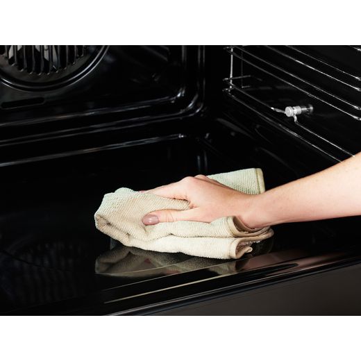 Stoves Richmond DX 90DF 90cm Dual Fuel Range Cooker - Anthracite - Person cleaning oven shot