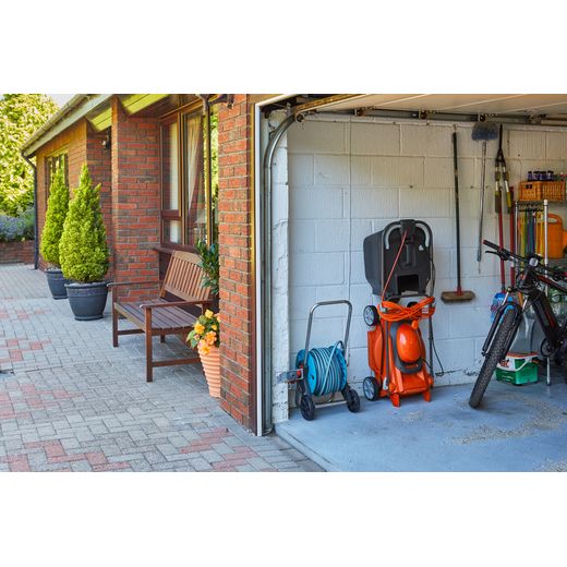 Flymo EasiStore 380R Corded Lawn Mower - Sunset Orange - mower in garage shot