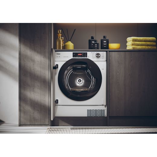 Haier 31900541 Integrated Heat Pump Tumble Dryer - White - Tumble dryer in laundry room with door open