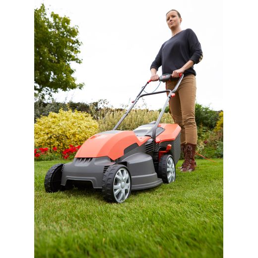 Flymo Speedi-Mo 360C Corded Lawn Mower - Orange - person cutting grass shot