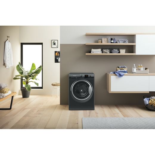 Hotpoint Anti-Stain NSWM 846 BS UK 8kg Washing Machine with 1400 rpm - Black - Washing machine in utility room shot 