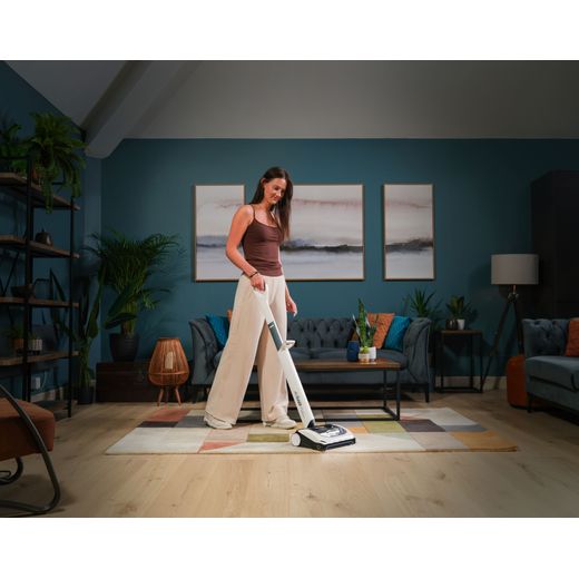 Gtech AirRam Platinum 1-03-273 Cordless Vacuum Cleaner with up to 60 Minutes Run Time - Silver - Women hoovering floor shot