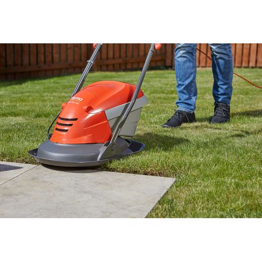 Flymo HoverVac 250 Corded Lawn Mower - Orange - person cutting grass shot