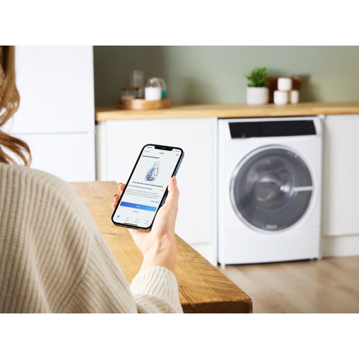 Bosch Series 8 i-Dos 10.5Kg / 6Kg Washer Dryer - White - Women using phone shot