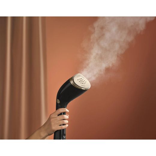 Philips 7000 series STH7060/86 Handheld Garment Steamer - Black / Gold - person using steamer shot