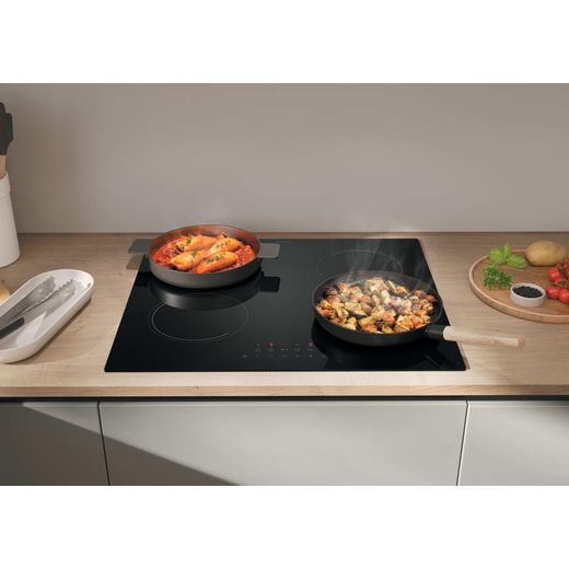 Candy Idea CII647CCAR 59cm Induction Hob - lifestyle - hob in kitchen with pans of food on top, front angle shot