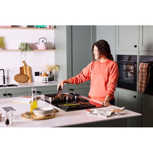 NEFF V68AUX4C0 Induction Hob Black - Women in kitchen shot