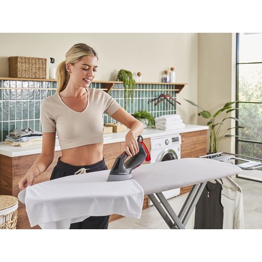 Morphy Richards 361001 Handheld Garment Steamer - Cosmic Red - Women using steamer on ironing board shot