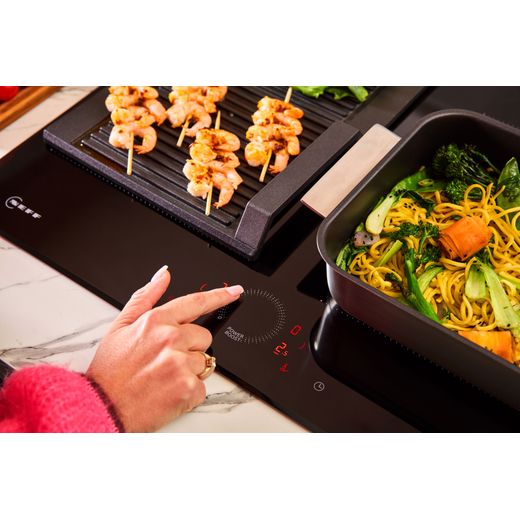 NEFF N70 T66FHX4L0 59cm Induction Hob - Black - person suing dial shot