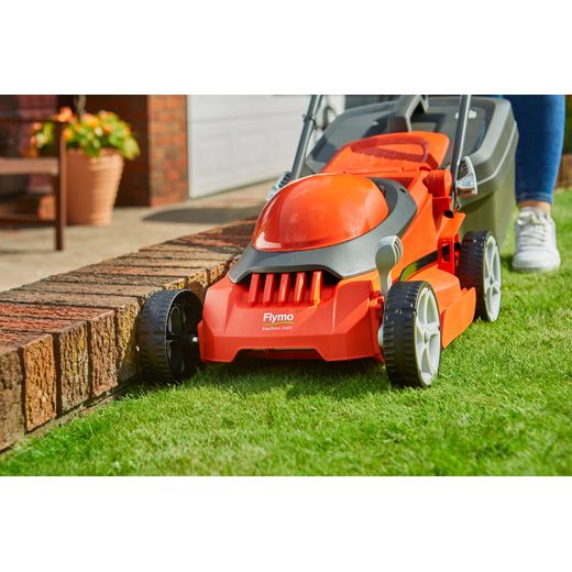 Flymo EasiStore 340R Corded Lawn Mower - Black / Orange - mower cutting grass shot