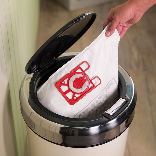 Henry Xtra HVX160-11 Cylinder Vacuum Cleaner - person putting dust bag in bin shot