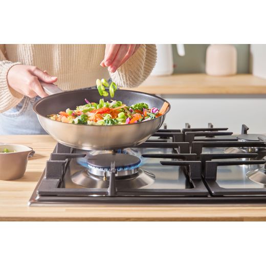Bosch Series 6 PCP6A5I90 58cm Gas Hob - Stainless Steel - person cooking food shot