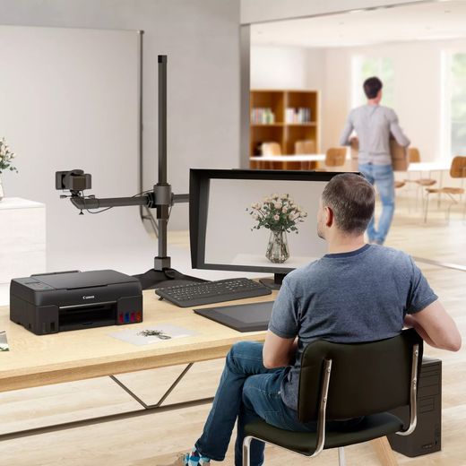 Canon PIXMA G650 Wireless Inkjet Printer - Black - Man in photo studio with printer on desk