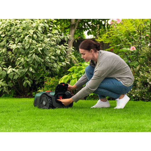 Bosch VisiMow18V-200 Lawn Mower, Including Battery - Women plugging in battery shot