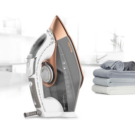 Breville DiamondXpress VIN401 3100 Watt Iron -White / Rose Gold - Iron on table top near folded clothes shot