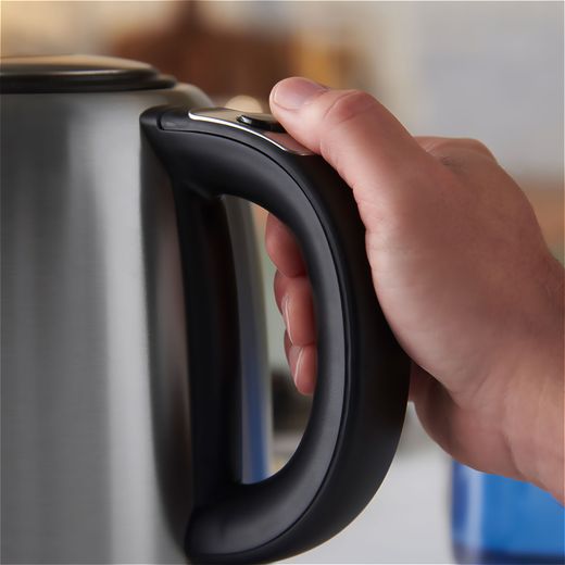 Russell Hobbs Quiet Boil 20460 Kettle - Stainless Steel - Person holding kettle shot
