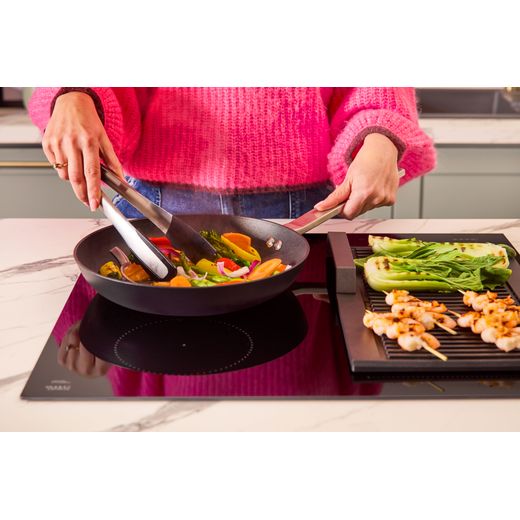 NEFF N70 T56FHS1L0 59cm Induction Hob - Black - person cooking food shot