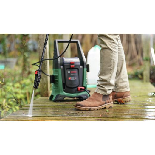 Bosch 0.600.8C7.070 Pressure Washer Green - Person cleaning decking shot