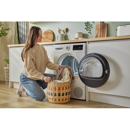 Bosch Series 6 WQG24502GB 9Kg Heat Pump Tumble Dryer - White - women loading washing shot