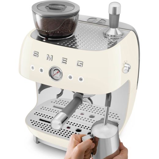 Smeg EGF03CRUK Coffee Machines Almond Cream - Women using hot milk and jug shot
