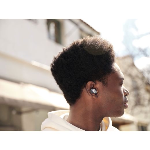 Beats Studio Buds + True Wireless Noise Cancelling In-Ear Headphones - Transparent - Man wearing headphones on street
