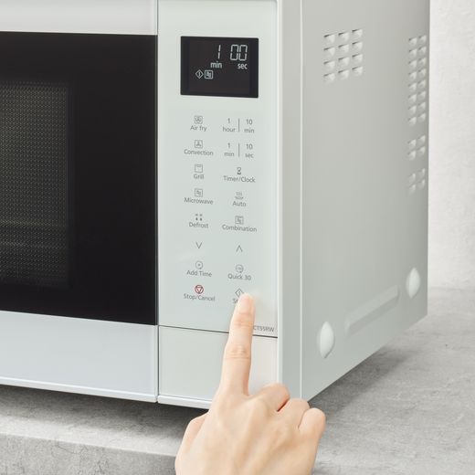 Panasonic 4-in-1 Air Fry NN-CT55RWBPQ 27 Litre 31cm High, Freestanding Small - White - person using microwave shot