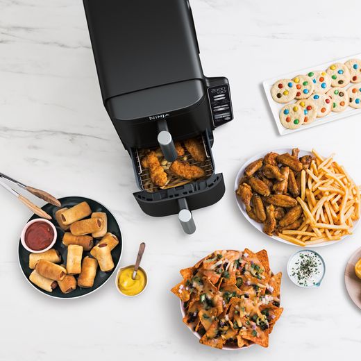 Ninja Double Stack XL SL300UK - Grey - Air fryer surrounded by cooked food