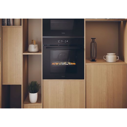 Haier ID Series 2 Built In Electric Single Oven - Black - Oven cooking food in kitchen shot