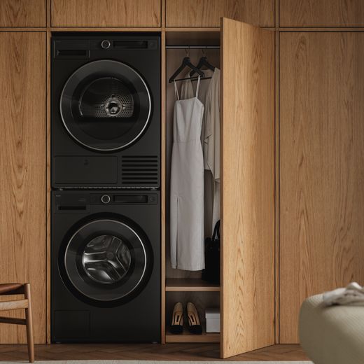 ASKO T509HRG.UK Wifi Connected 9Kg Heat Pump Tumble Dryer - Graphite Black - Washing machine and tumble dryer stacked in room