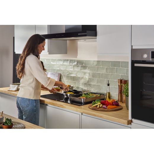 Bosch Series 6 PXV831HC1E 80cm Induction Hob - Black - women cooking on hob