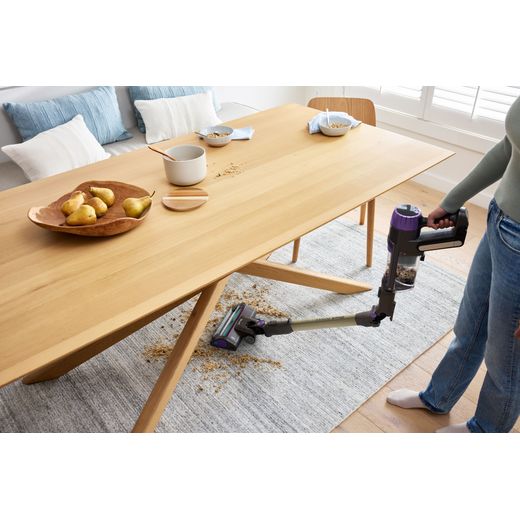 Shark PowerDetect Clean & Empty IP3251UKT Cordless Vacuum Cleaner with up to 70 Minutes Run Time - White / Java Grey - Person hoover under table shot