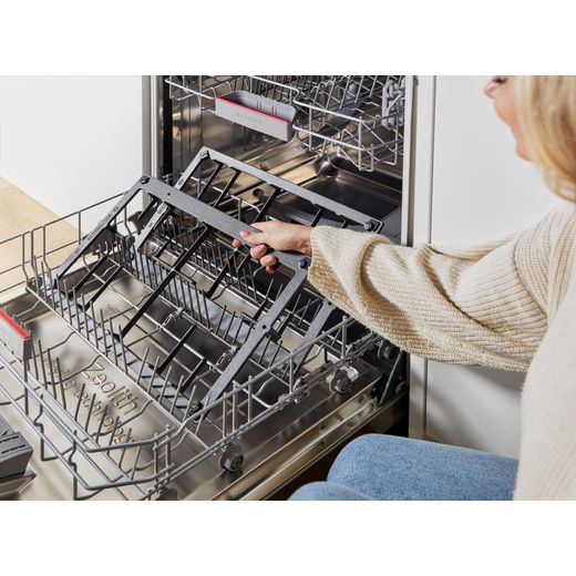 Bosch Series 6 PCP6A5I90 58cm Gas Hob - Stainless Steel - person putting pan support in dishwasher