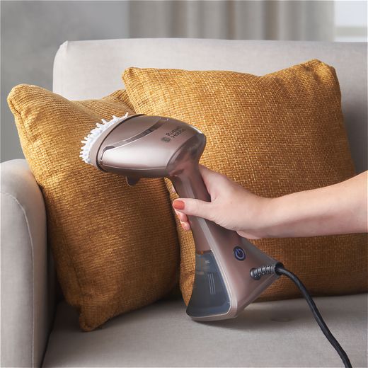Russell Hobbs Steam Genie Aroma 28040 Handheld Garment Steamer - Grey - Person steaming cushion shot
