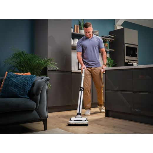 Gtech AirRAM 3 1-03-270 Cordless Vacuum Cleaner with up to 30 Minutes Run Time - White - Man hoovering in kitchen shot
