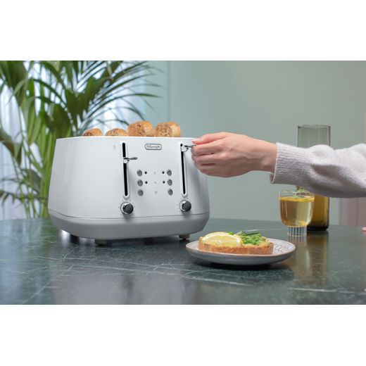 De'Longhi Eclettica CTY4003.W 4 Slice Toaster - White - Person using toaster on table shot