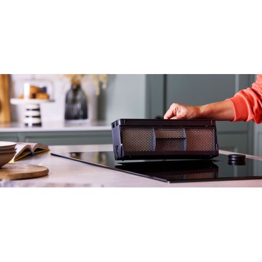 NEFF V68AUX4C0 Induction Hob Black - Person removing filter shot