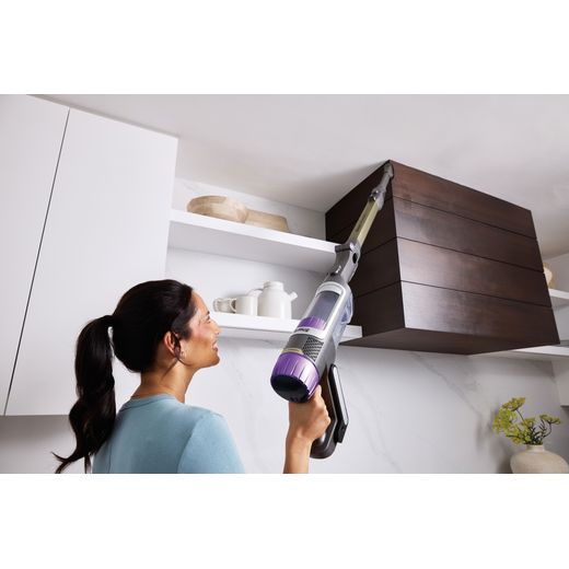 Shark PowerDetect Clean & Empty IP3251UKT Cordless Vacuum Cleaner with up to 70 Minutes Run Time - White / Java Grey - Women hoover top of cupboards shot