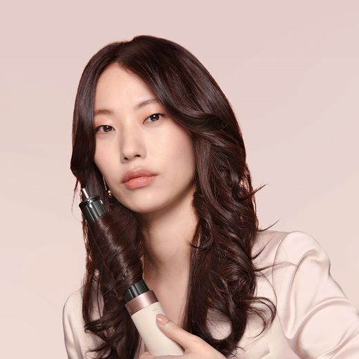 Dyson Airwrap Co-anda 2x™ Straight & Wavy 596885-01 Hot Air Styler - Ceramic Pink / Rose Gold - Women using airwrap shot