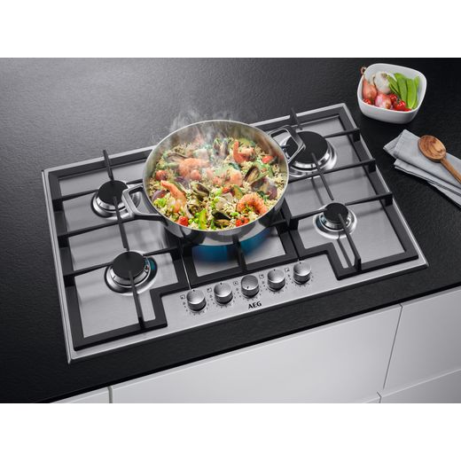 AEG 3000 Slim Line HGX75400SM 74cm Gas Hob - Stainless Steel - Food being cooked on gas hobs hot