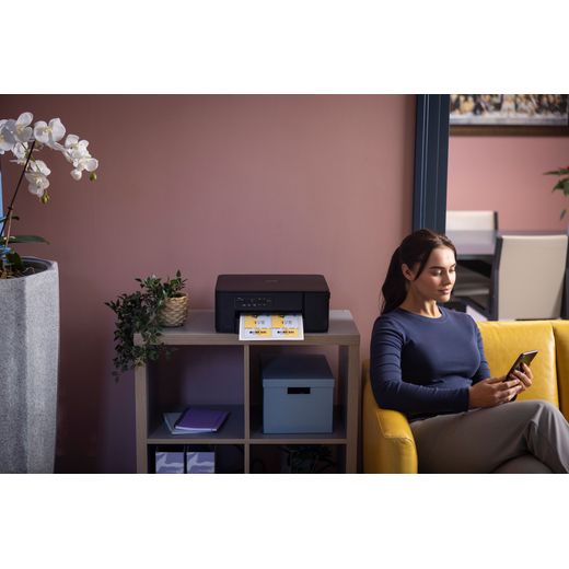 Brother DCP-J1260W Compact 3-in-1 Printer - Black - Woman sat next to printer