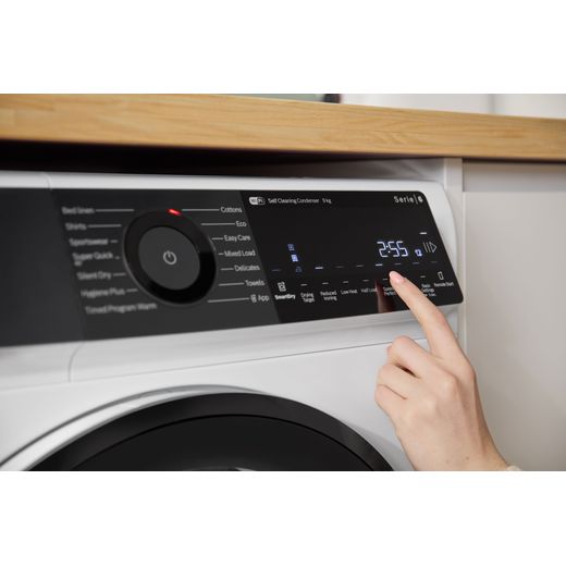 Bosch Series 6 WQH246D9GB 9Kg Heat Pump Tumble Dryer - White - person using control panel shot