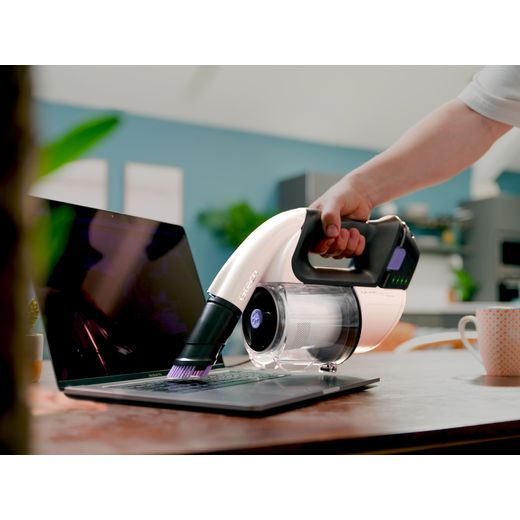 Gtech Multi Platinum 1-03-274 Cordless Vacuum Cleaner with up to 30 Minutes Run Time - Silver / Black - Person cleaning laptop keys shot