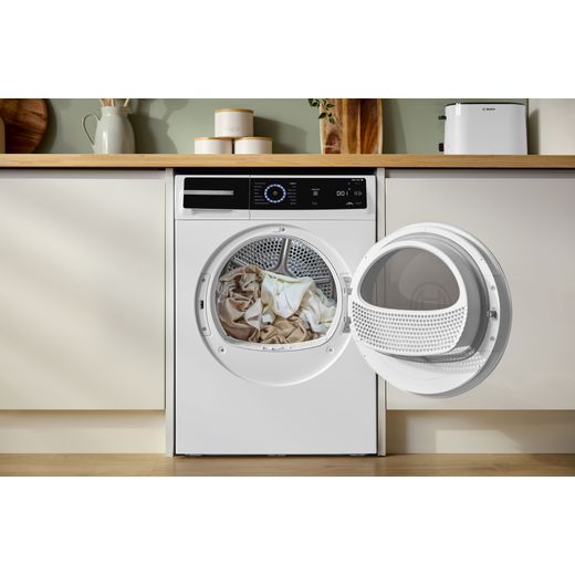 Bosch Series 8 WRB247C9GB 9Kg Heat Pump Tumble Dryer - White - machine with door open in kitchen shot