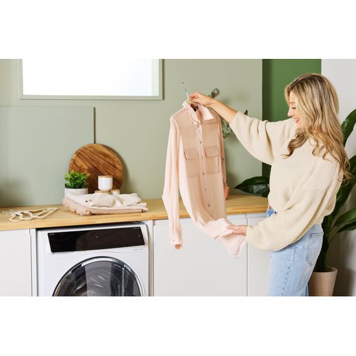 Bosch Series 8 i-Dos 10.5Kg / 6Kg Washer Dryer - White - WOmen checking clothes shot