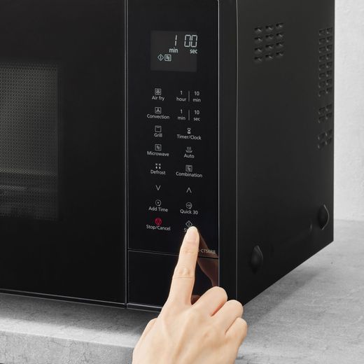 Panasonic 4-in-1 Air Fry NN-CT56RBBPQ 27 Litre 31cm High, Freestanding Small - Black - person using microwave shot