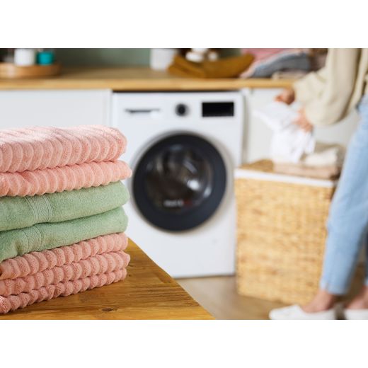 Bosch Series 6 10.5Kg / 6Kg Washer Dryer - White - Clothes folded on table shot