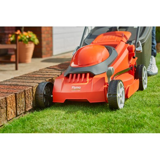 Flymo EasiStore 380R Corded Lawn Mower - Sunset Orange - mower cutting grass shot